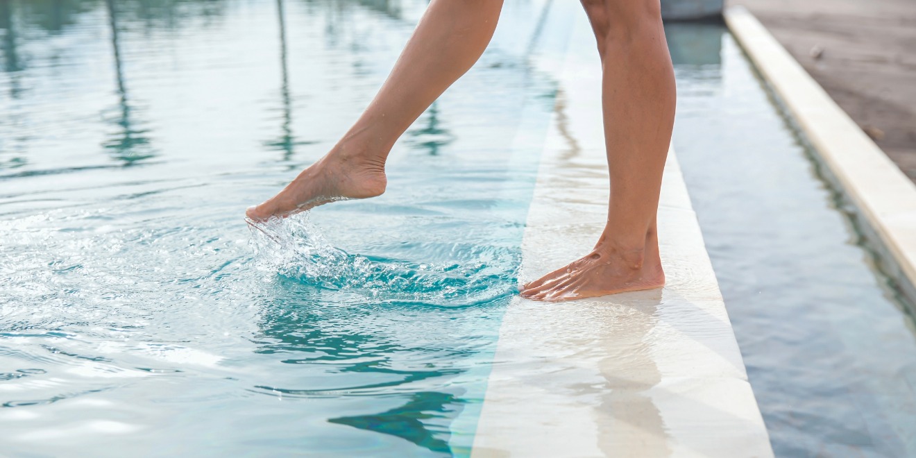 Dipping toes in pool to check water temperature