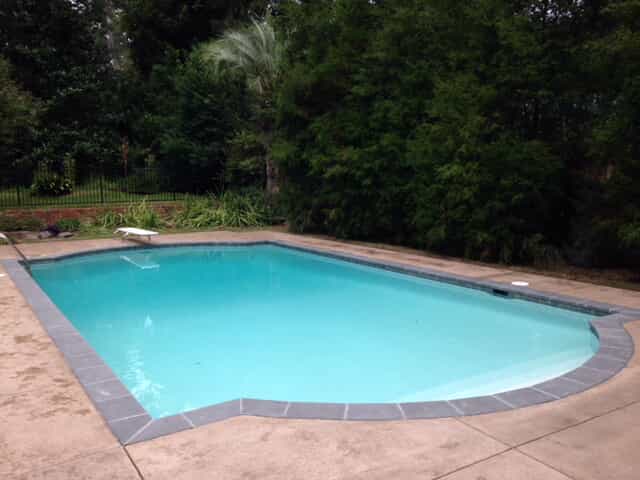 Deck and Coping Renovation, after replacement of the old swimming pool deck with 2-inch bluestone coping and textured colored concrete