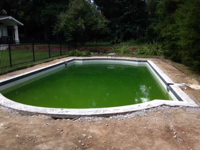 Deck and Coping Renovation, before replacement of the old swimming pool deck with 2-inch bluestone coping and textured colored concrete