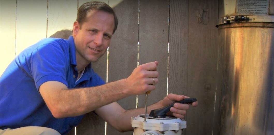 A Pool Technician Fixing Pool Equipment